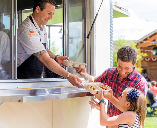 Chef serving family out of a food truck