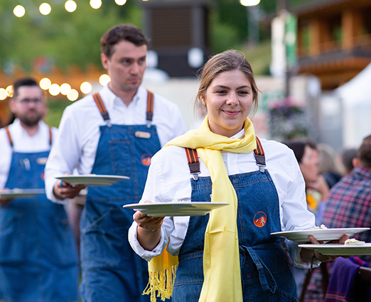 Servers at an outdoor dinner