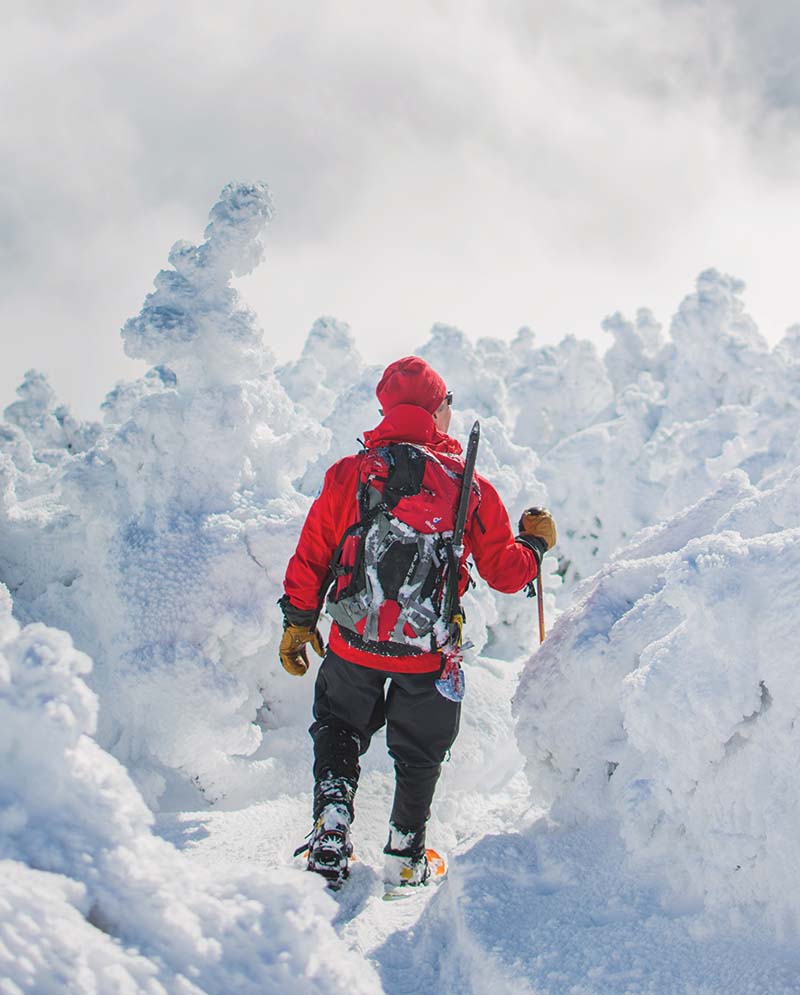 man walking in snow