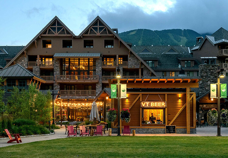 Chalet exterior front view with soft yellow lighting