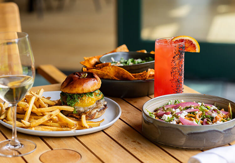 Burger, fries, nachos with pickled red onions, and drinks