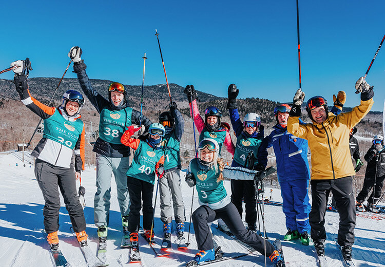 Group of people smiling in full skiing gear