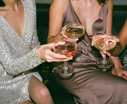 A group of women in fancy dress with champagne