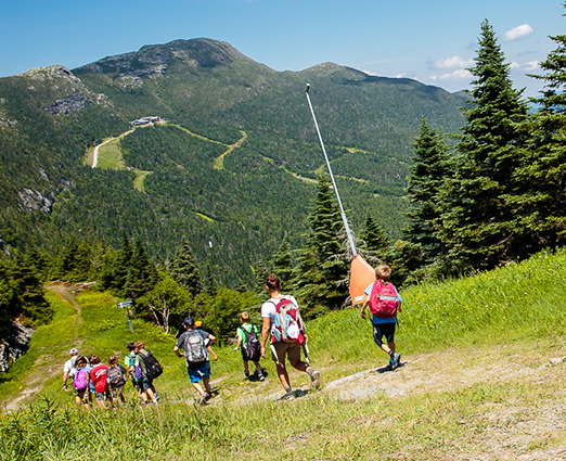 Group of kids hiking down a mountain