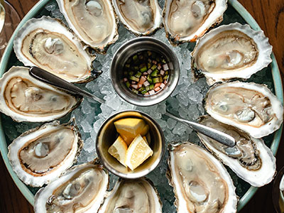 woman overlooking a hotel pool with fall mountains in the background
